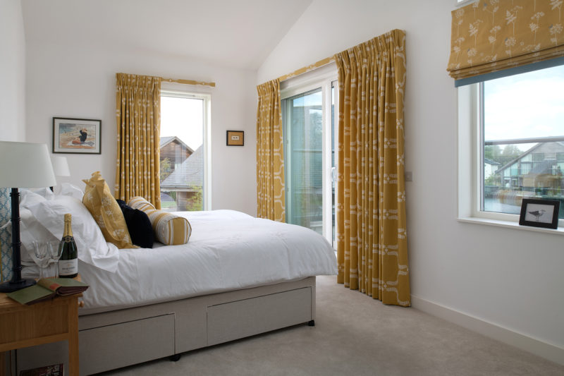 Spacious bedroom in a lakeside luxury stay in the Cotswolds